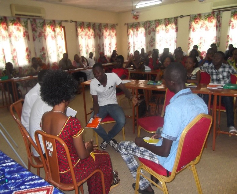 Participants at an NDI training in Burkina Faso for youth and women candidates act out door-to-door campaigning.