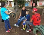 A youth organizer surveys members of the community about the most pressing issues affecting their neighborhood.