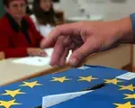 A Slovenian casts his ballot in a box bearing a European Union crest at a polling station in Grosuplje near Ljubljana, Sunday, Oct. 3, 2004. Credit: AP Photo/Darko Bandic