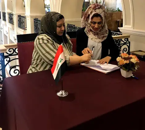 Newly-elected members of the Salahaddin WAB’s executive committee sign their bylaws into effect. Photo credit: NDI-Iraq